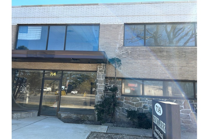 Doorway to property with stone siding