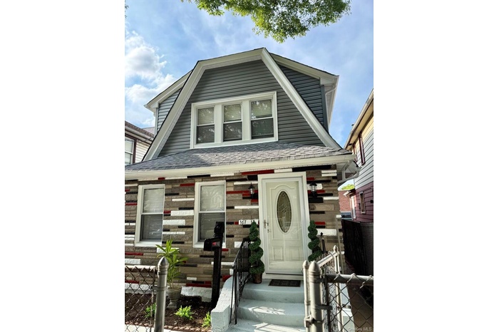 View of front of house with roof with shingles and entry steps