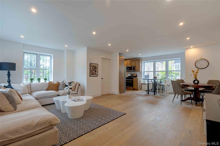 Living area with recessed lighting and light wood-style floors