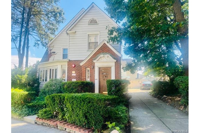 Traditional-style home featuring brick siding