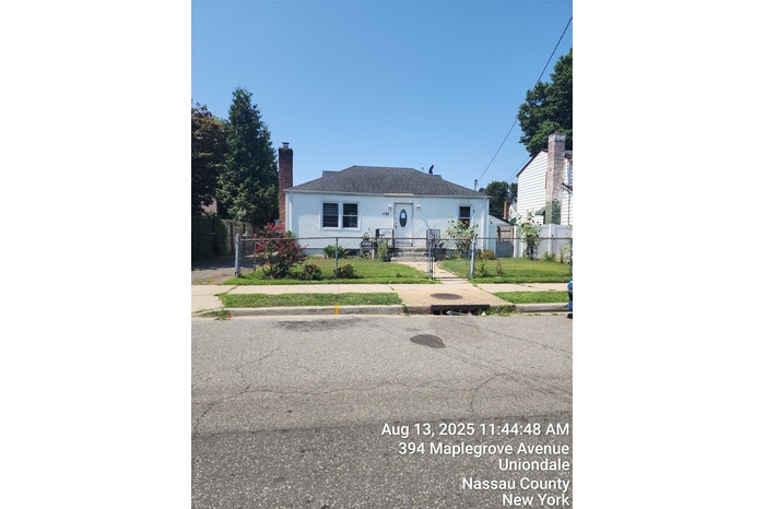Bungalow with a fenced front yard, a gate, and a chimney