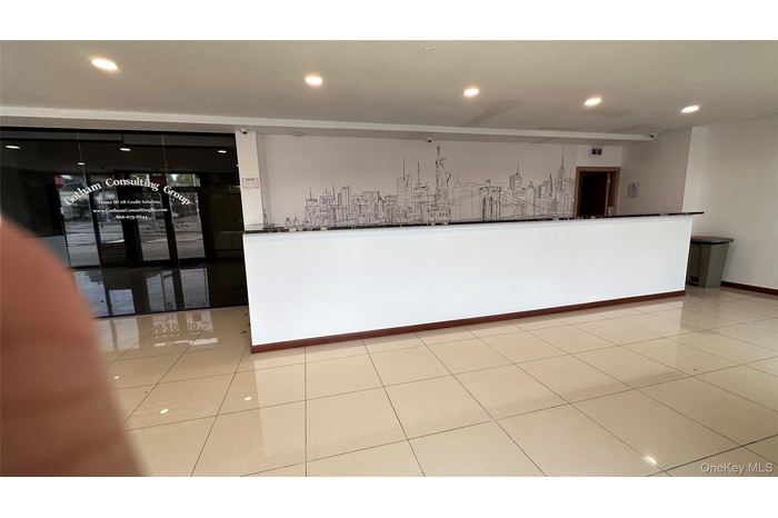Empty room featuring light tile patterned floors and recessed lighting