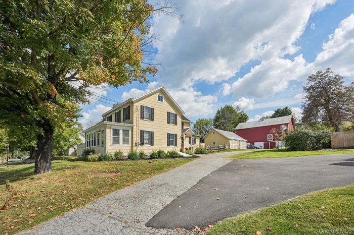 View of front of property with asphalt driveway