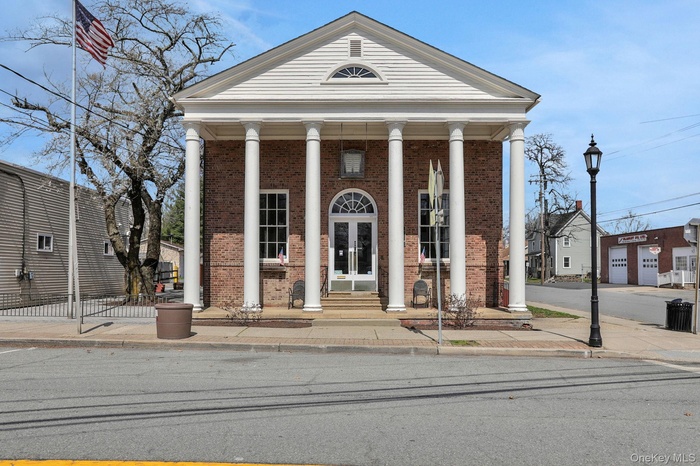 View of front of home with a porch, french doors, and brick siding