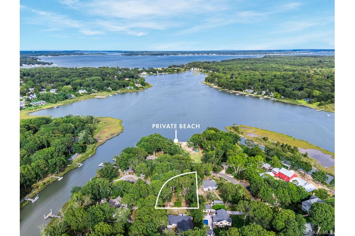Aerial view of property and surrounding area featuring a large body of water and property boundaries highlighted