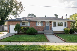 Beautifully maintained 3 Bedroom 2 Full Bath Ranch in desirable East Meadow, Hard wood floors throughout.