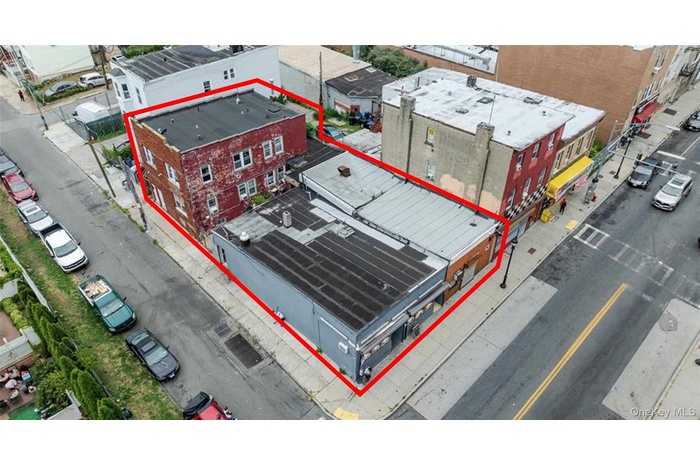 Aerial view of property and surrounding area featuring property parcel outlined