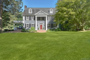 Refined and elegant Circa 1927 Colonial, nestled on one of Chappaqua s most coveted streets, exudes timeless charm while offering modern comforts.