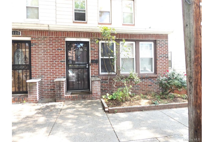View of exterior entry featuring brick siding