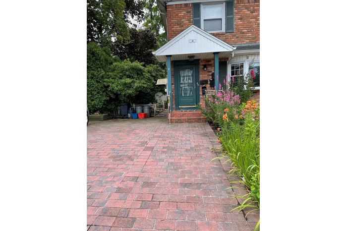 Property entrance featuring brick siding