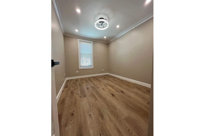 Spare room with ornamental molding, wood finished floors, and recessed lighting