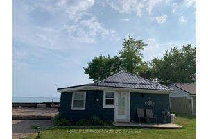 Welcome to 18222 Erie Shore Drive, a rare waterfront property featuring two lots combined into one expansive parcel along the shores of Lake Erie.
