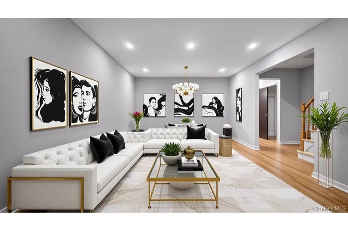 Living room with a chandelier, light wood-style flooring, recessed lighting, and stairway