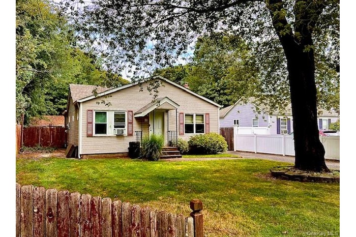 Bungalow-style home with cooling unit