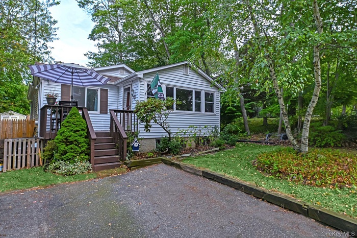 View of front of house with view of scattered trees