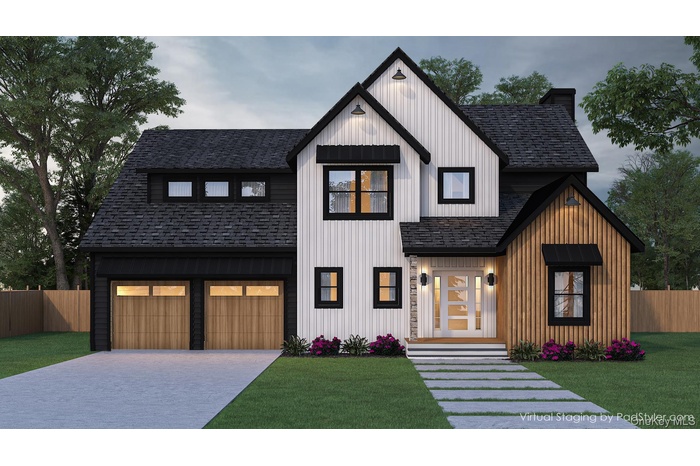 Modern farmhouse style home featuring a shingled roof, decorative driveway, and a garage