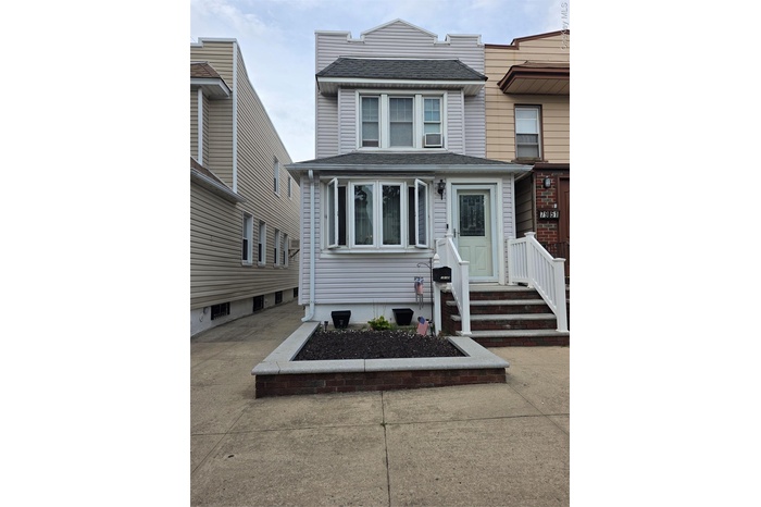 View of front of home featuring roof with shingles