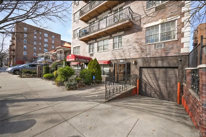 View of property featuring an attached garage and driveway