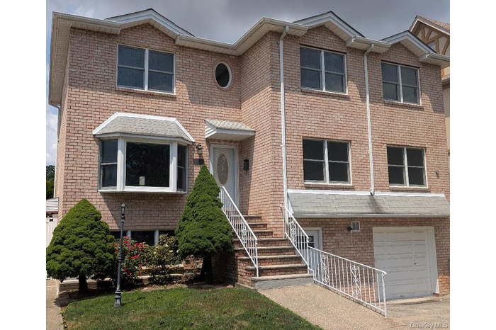 Traditional home featuring brick siding and a garage