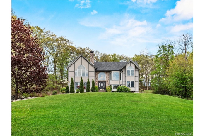 English style home featuring a front yard