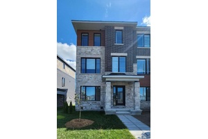 A brand new, never lived in end unit townhome with 2 parking garages in the highly desirable Kanata Lakes Arcadia community !