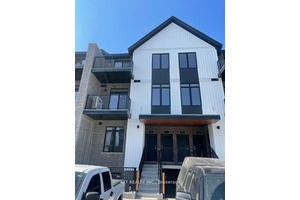This exceptional two story townhouse is graced with elegance.