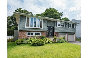 Tastefully updated 4 bedroom, 2 full bath hi ranch, emphasizing all major upgrades.