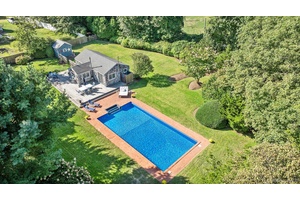 Privately situated amp ; set back from the road, this charming East Hampton cottage features over 1 2 an acre of cleared, luscious property.