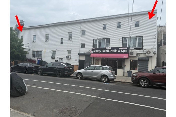 View of building exterior featuring cooling unit and ac unit