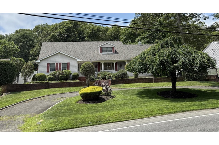 Cape cod-style house with circular driveway and set back from road