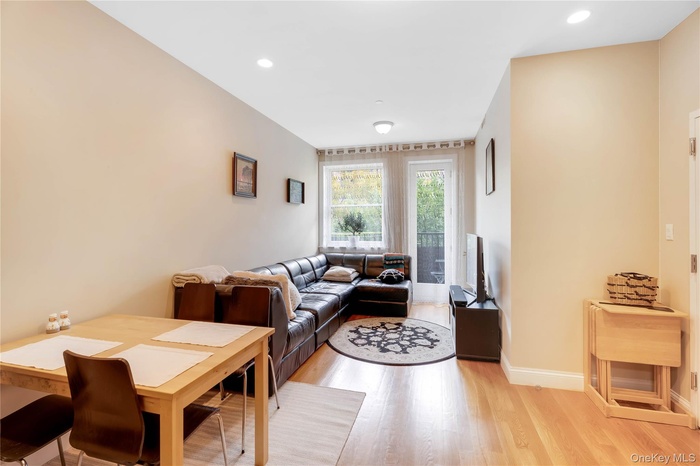 Living area featuring light wood-style floors and recessed lighting