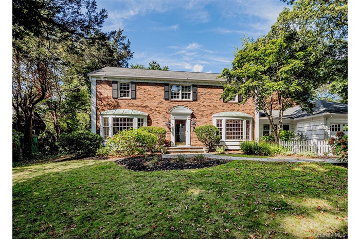 Colonial home with brick siding