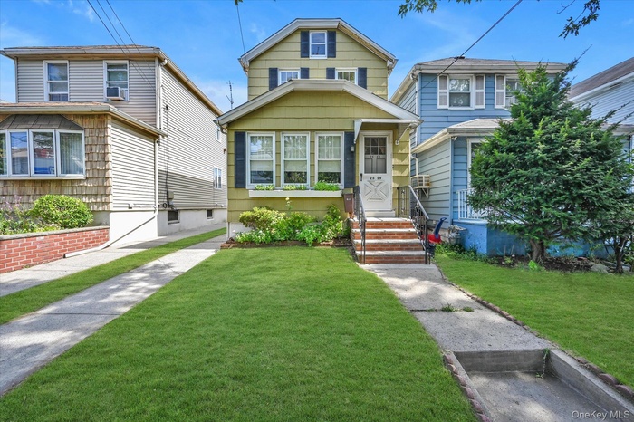American foursquare style home with a front lawn