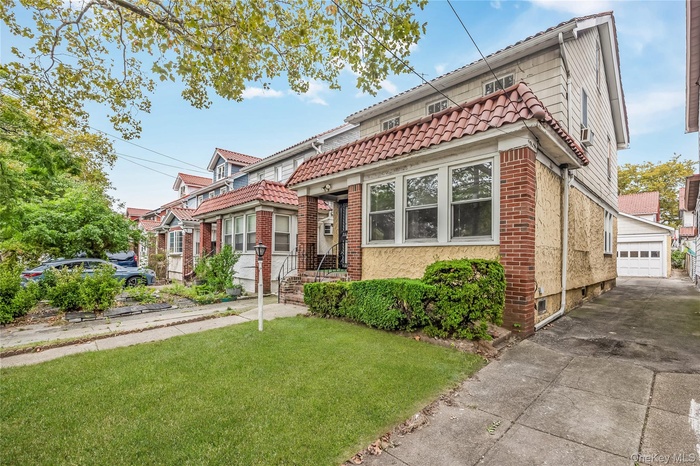 View of front facade featuring a front lawn and brick siding