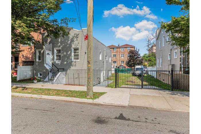 View of front of house featuring a fenced front yard and a gate