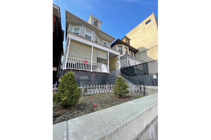 View of front of house with stairs and covered porch