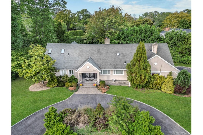 View from above of property with a tree filled landscape
