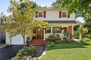 Lovely Light Filled Colonial with Views of the Private Setting !