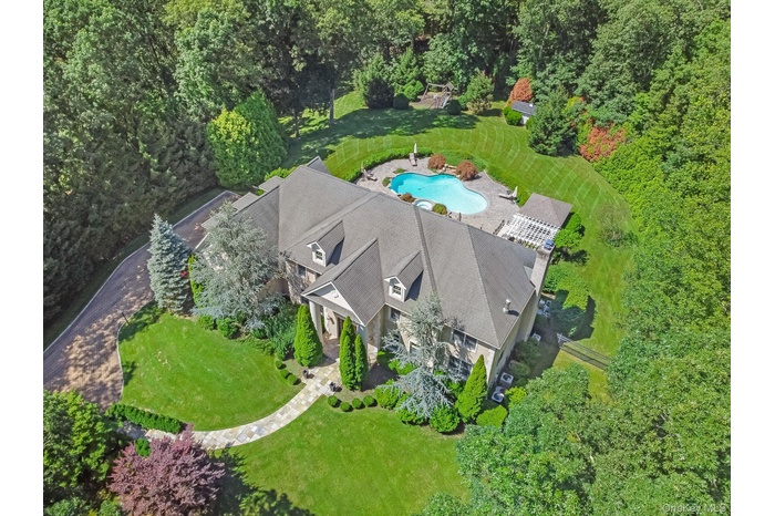 View from above of the property featuring a pool area and a front yard