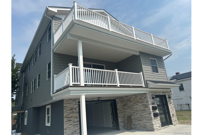 Property entrance featuring a patio and stone siding