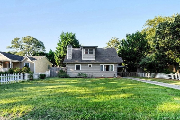 Rear view of property featuring a chimney