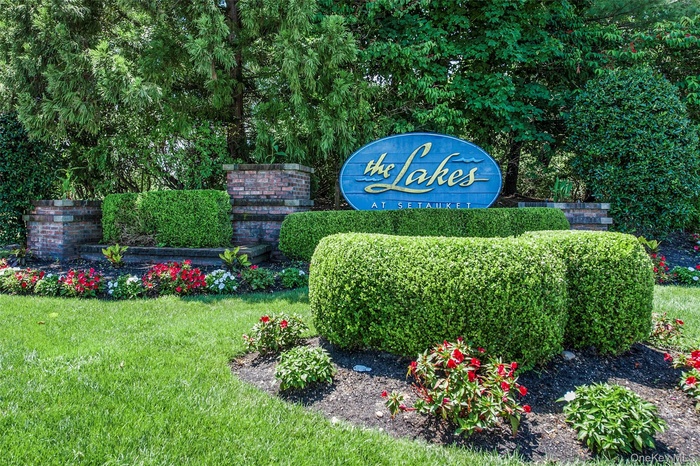 Community / neighborhood sign with a yard