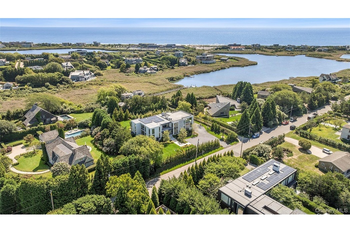 Aerial view of residential area featuring a large body of water