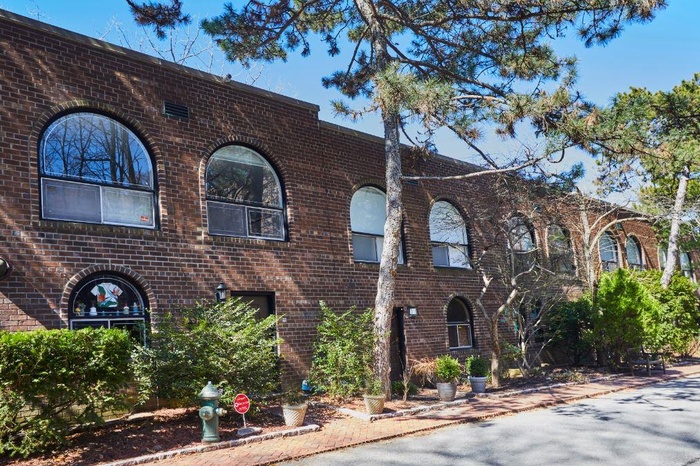Townhome / multi-family property featuring brick siding