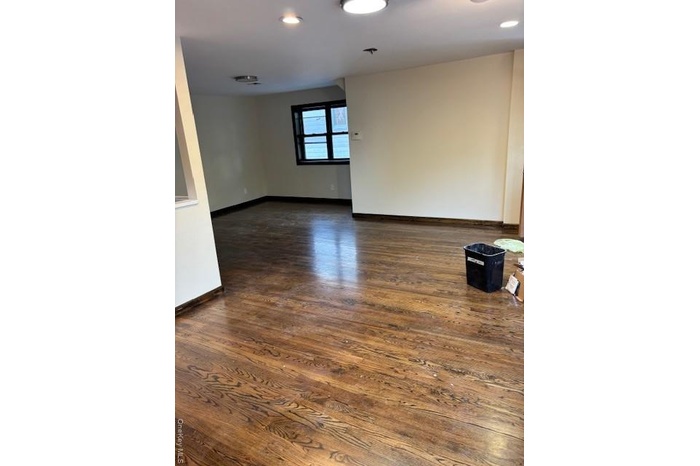 Spare room with dark wood-type flooring and recessed lighting