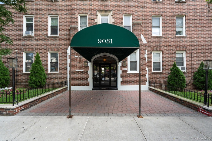 View of exterior entry featuring french doors and brick siding