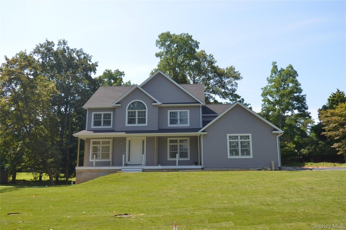 View of front of property with a front lawn and a porch