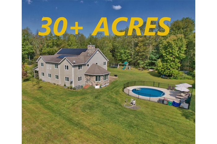 View from above of property featuring a pool area