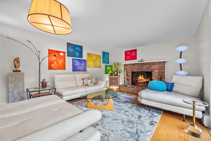 Living area featuring wood finished floors and a fireplace