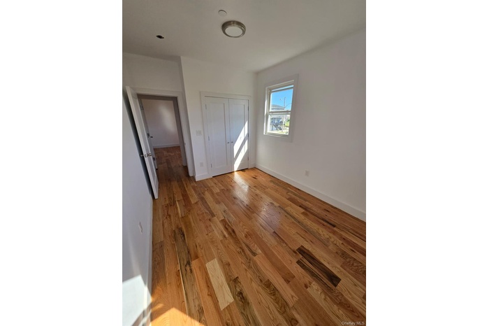 Unfurnished bedroom featuring light wood finished floors and a closet